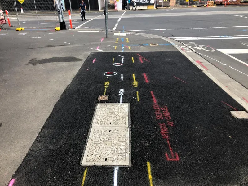 A full site mark-out on fresh asphalt with depths labelled