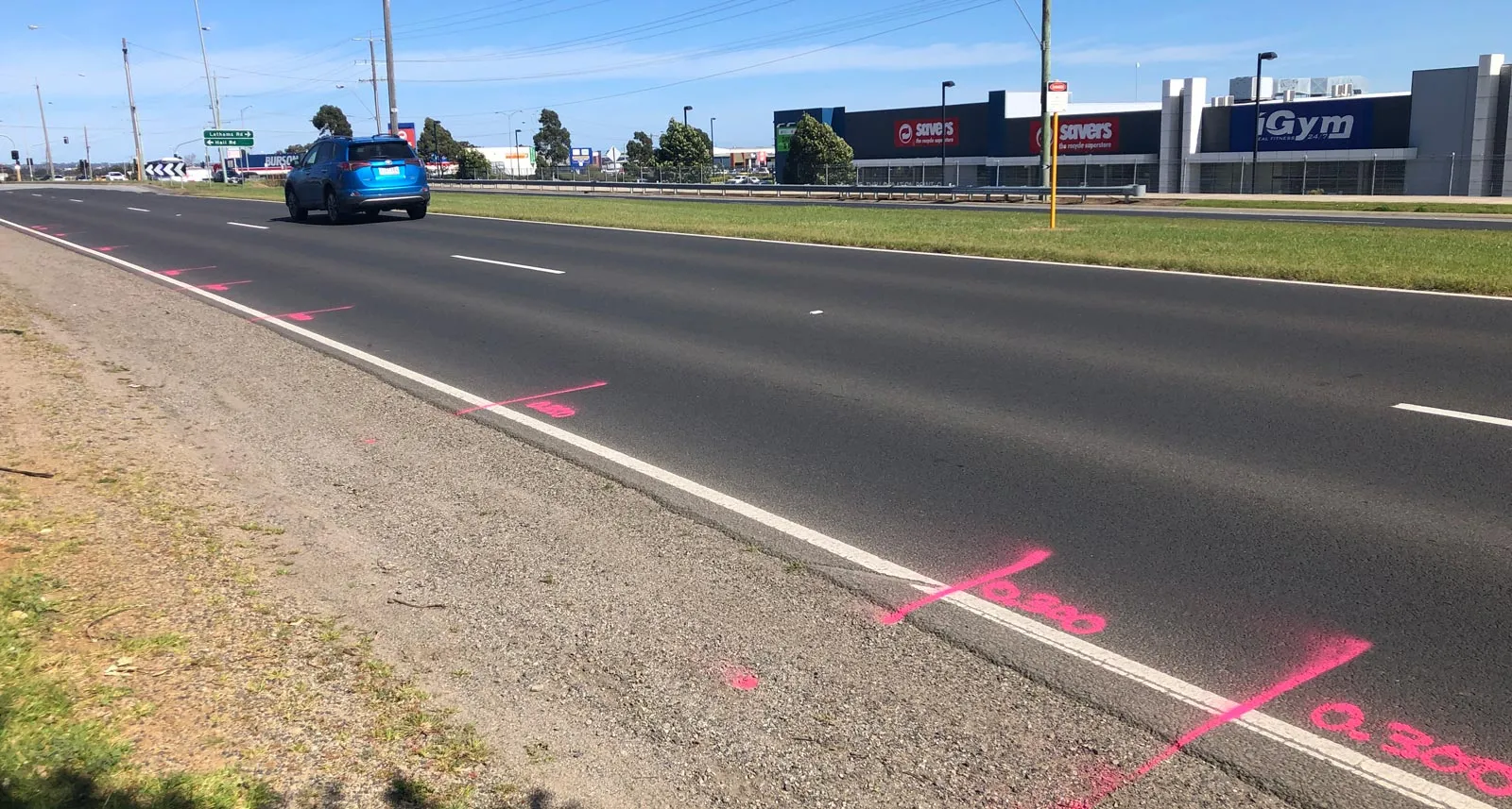 Pink locate marks along a highway verge after a GPR scan