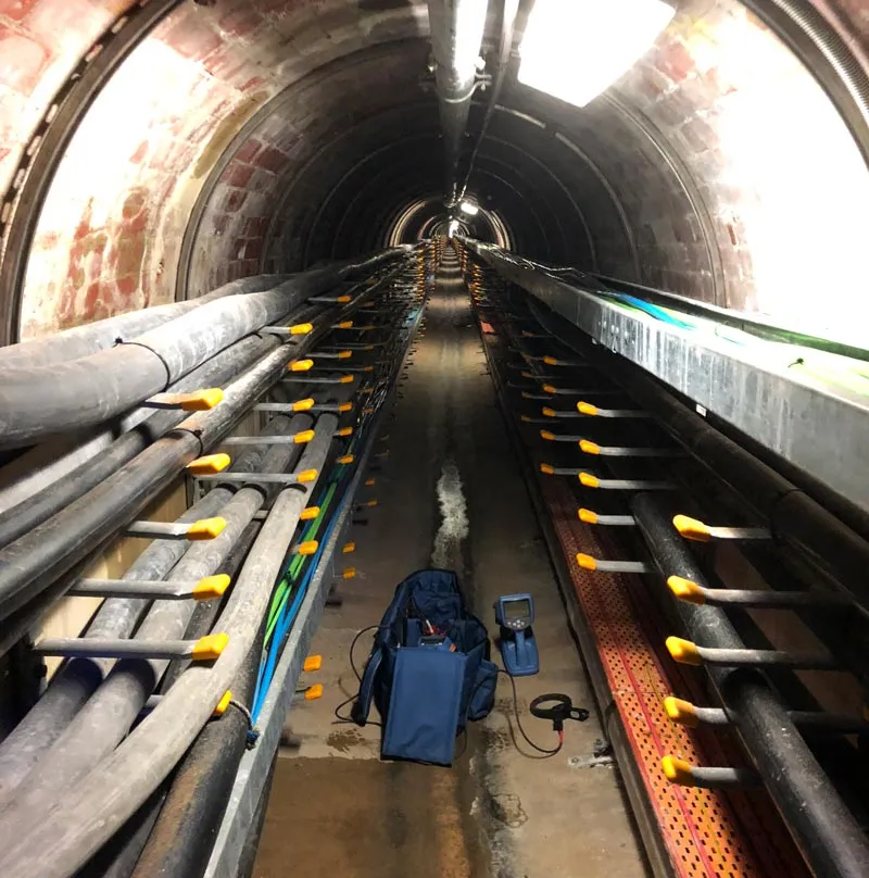Cable trays running through an underground service tunnel